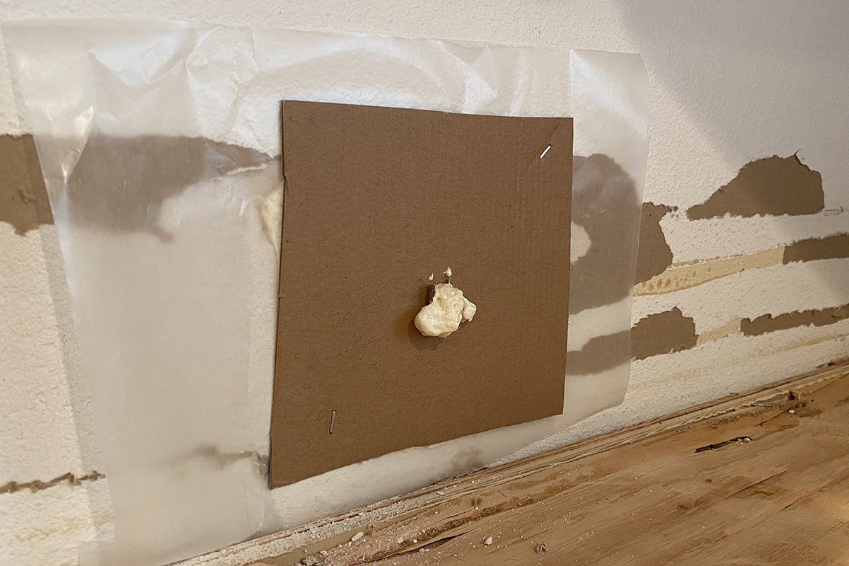 Foam spilling out of my cardboard forms stapled on the wall.