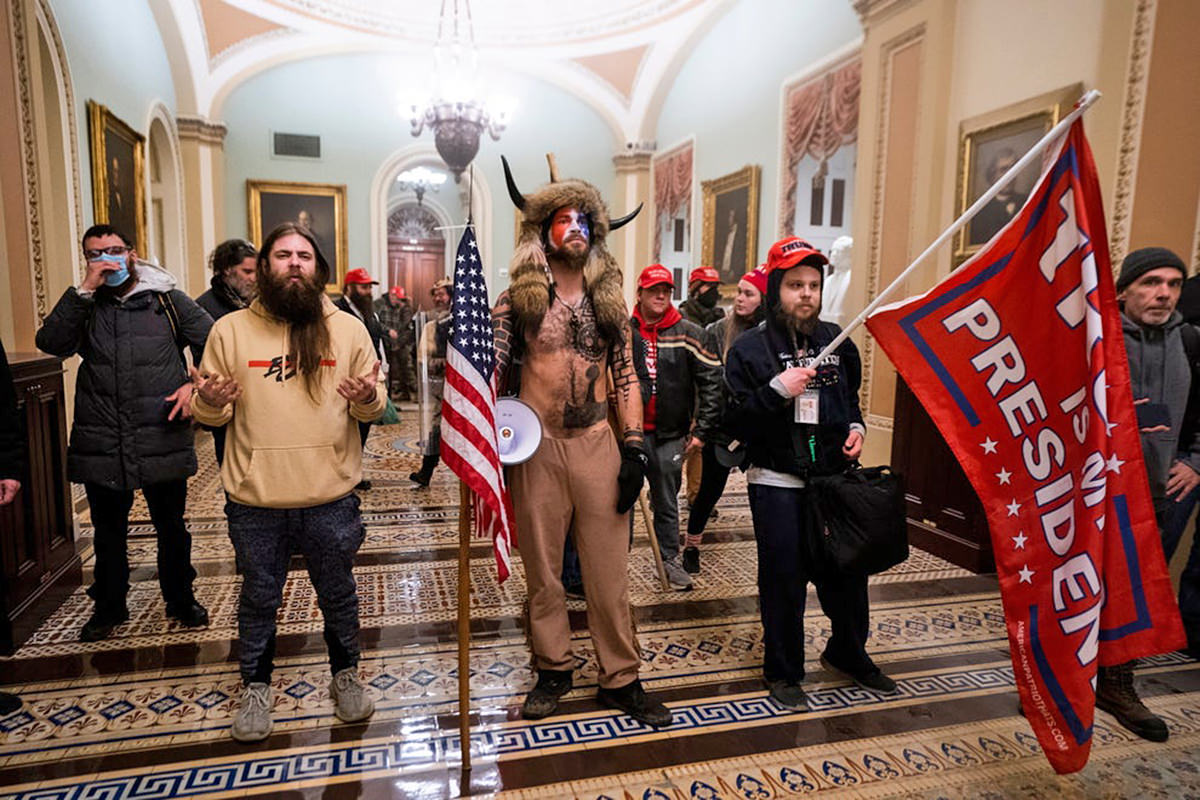 A bunch of white people storming the Capitol... one of them dressed up in viking horns.