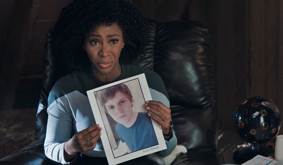 Monica Rambeau holding up a headshot of actor Ralph Bohmer.