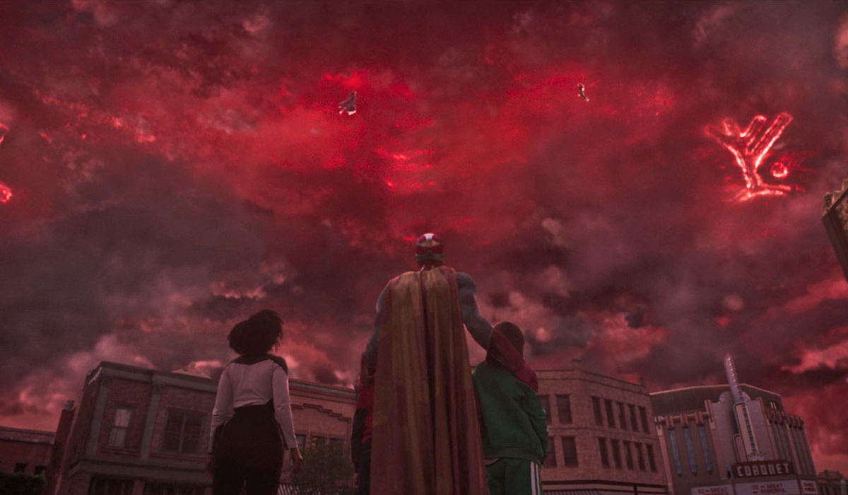 Wanda floating in red skies battling Agatha Harkness while Vision and her children look upward.