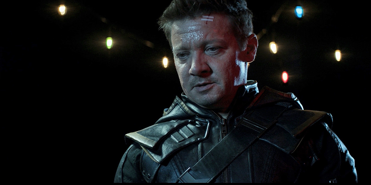 Clint Barton dressed as Ronin looks down at a defeated Maya.