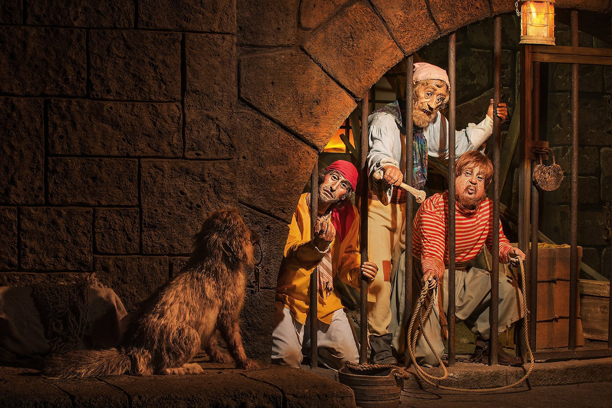 A scenes of prisoners trying to get a dog to give them the keys to their cell in the Pirates of the Caribbean ride at Disneyland.