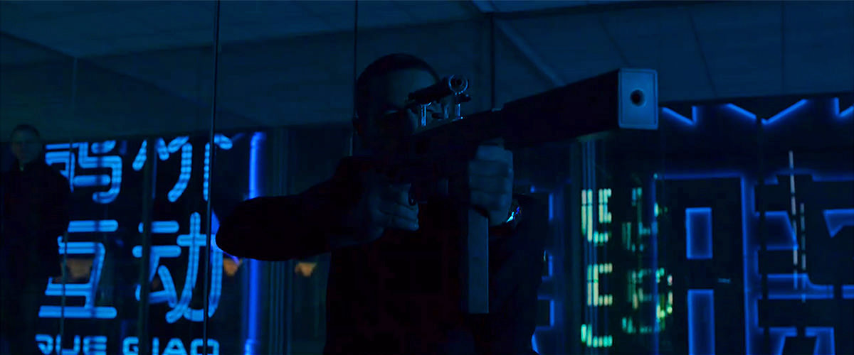 James Bond out to get an assassin with colorful lights and images reflecting on glass walls.